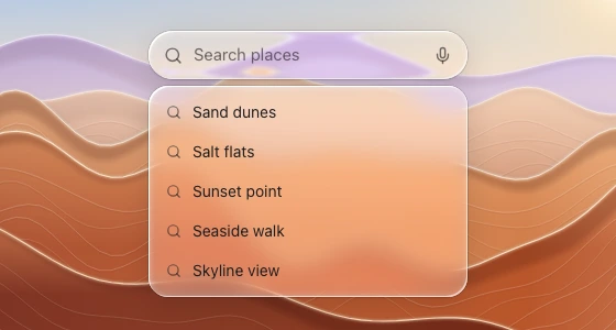 A capsule search field with a separate suggestion list below it, over zoomed desert ridges.