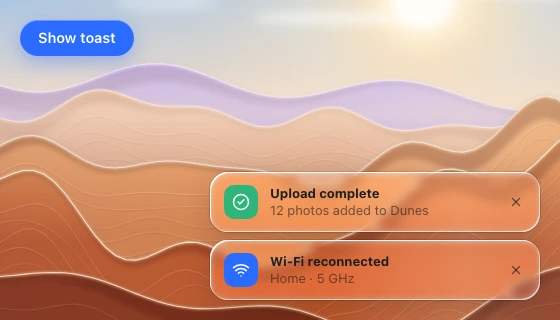 Two stacked notification cards at the lower right, with a solid trigger button at the top left, over zoomed desert ridges.